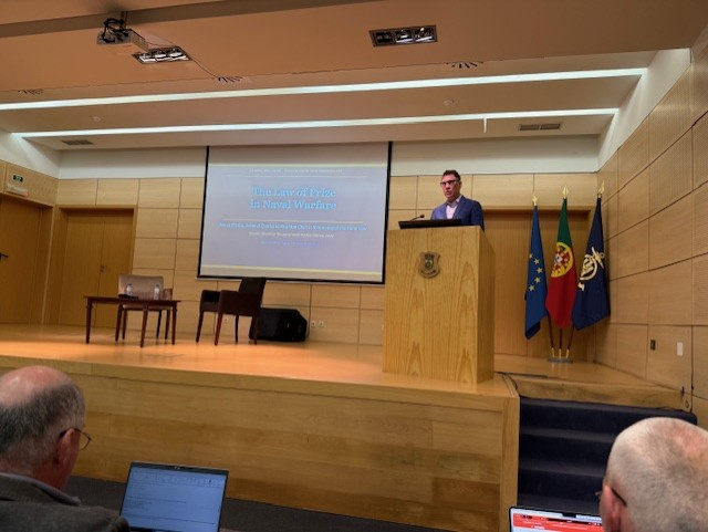 A man speaking at a podium in an auditorium